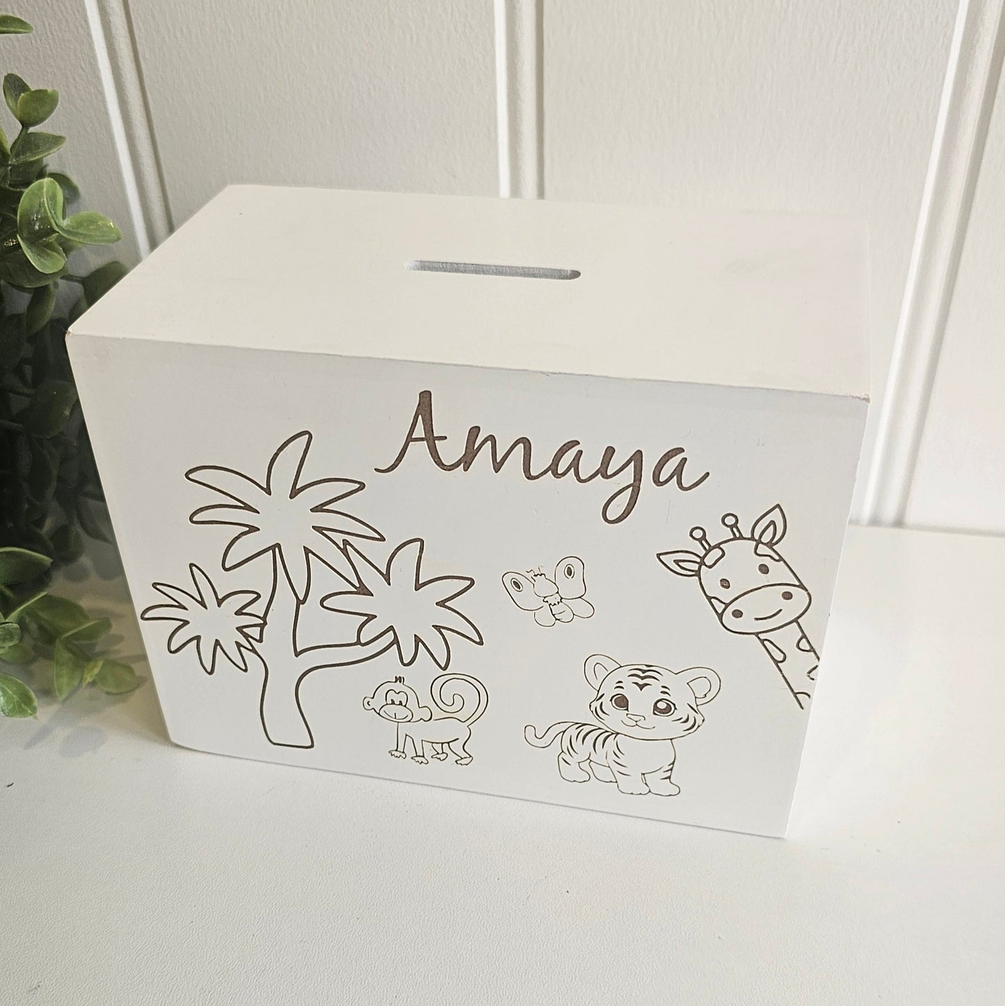 White box with 'Amaya' and jungle-themed illustrations on a white surface.