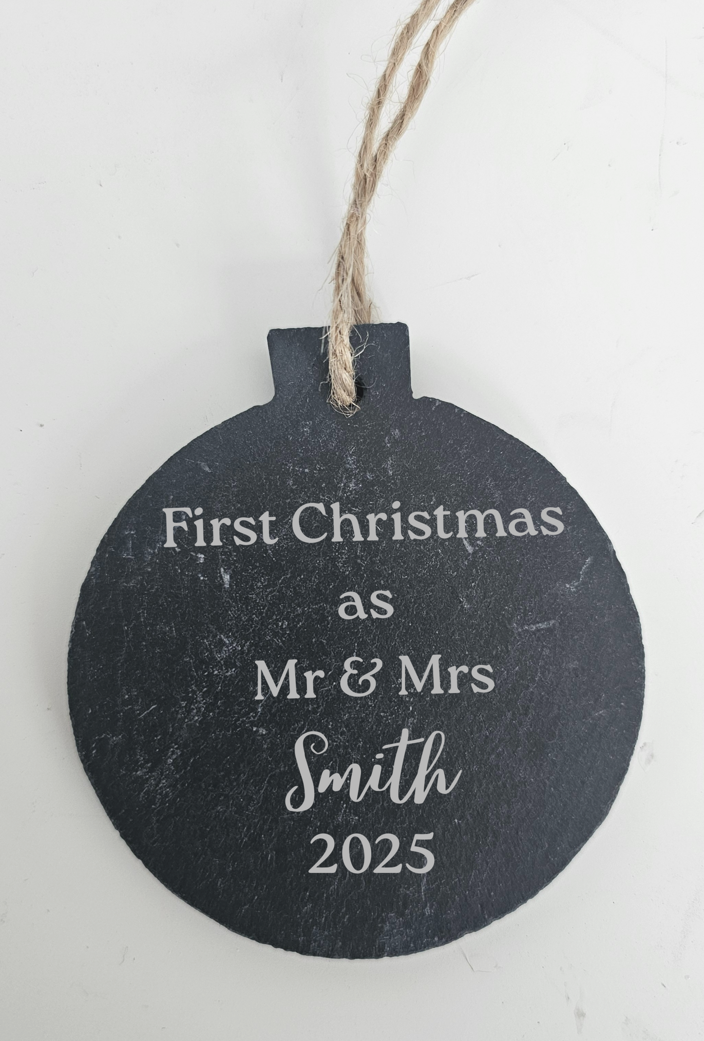 Decorative ornament with 'First Christmas as Mr & Mrs Smith 2025' text on a white background