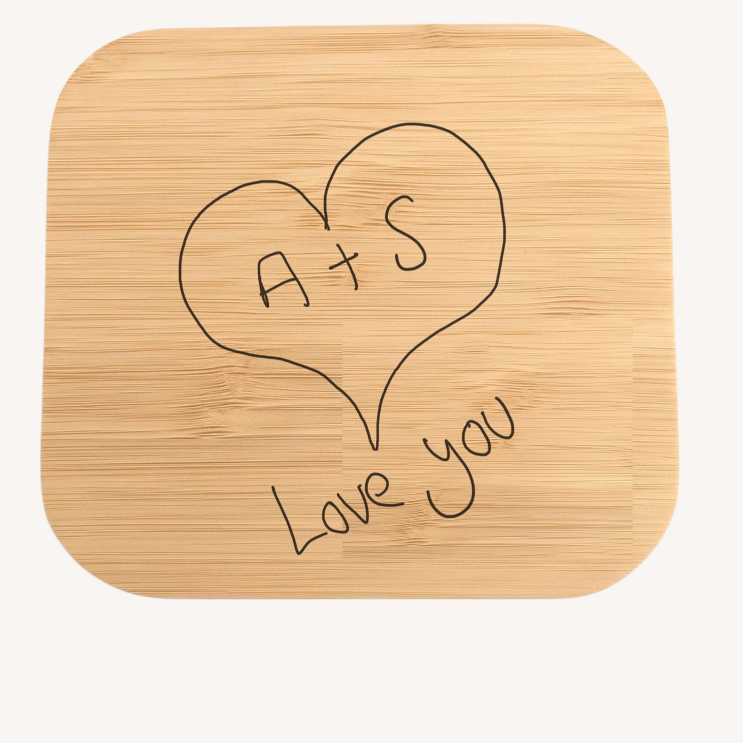 Bamboo wireless charger with 'A+S Love You' engraving on a white background