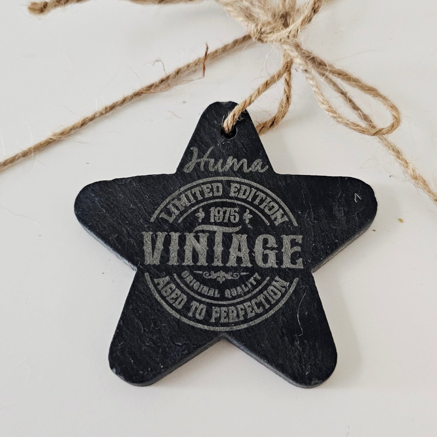 Star-shaped black tag with 'Vintage' text on a white background