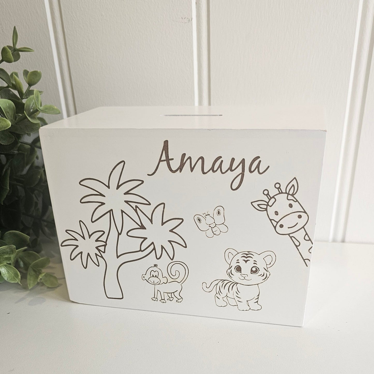 White decorative box with animal illustrations and the name 'Amaya' on a white surface.