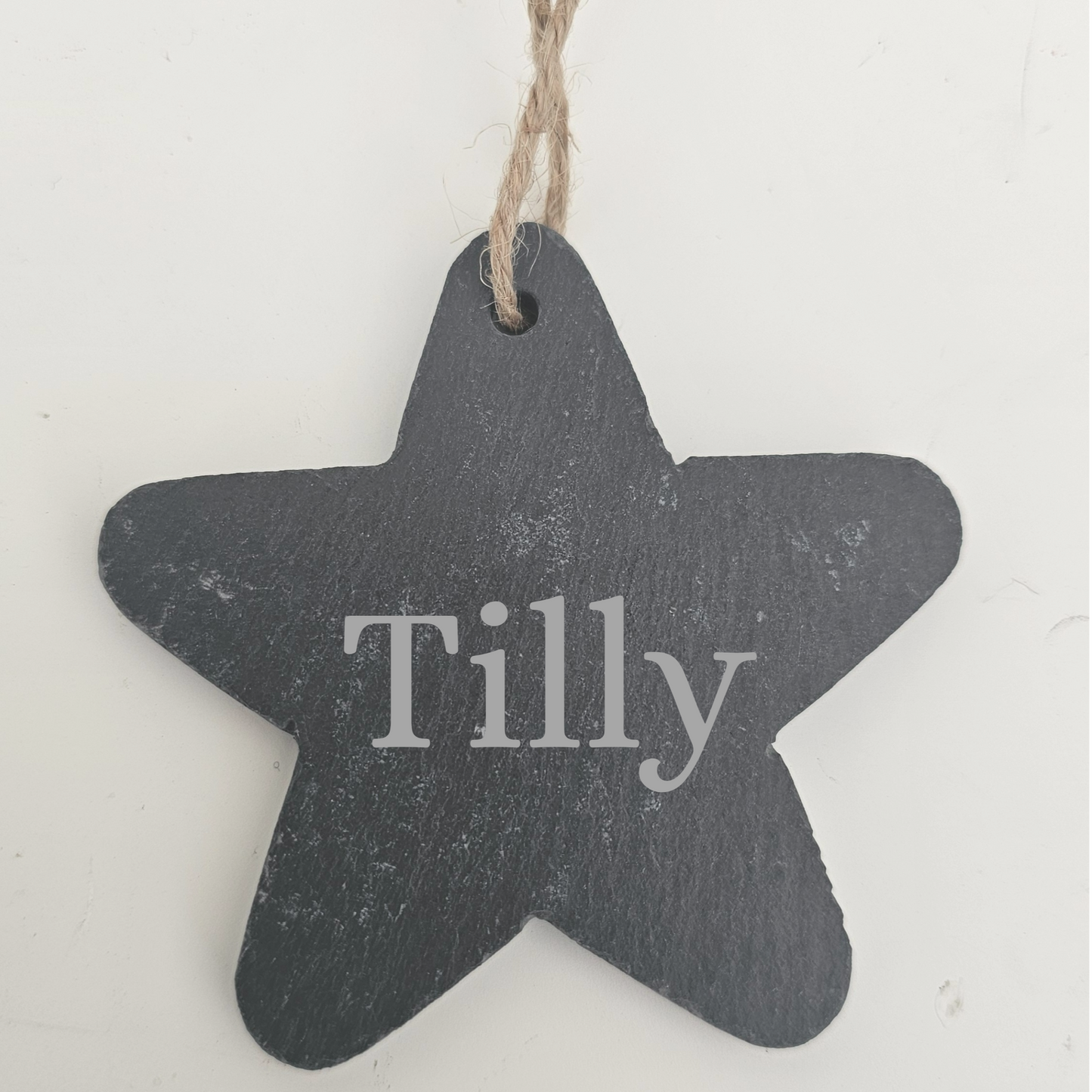 Star-shaped slate tag with 'Tilly' engraved on a white background