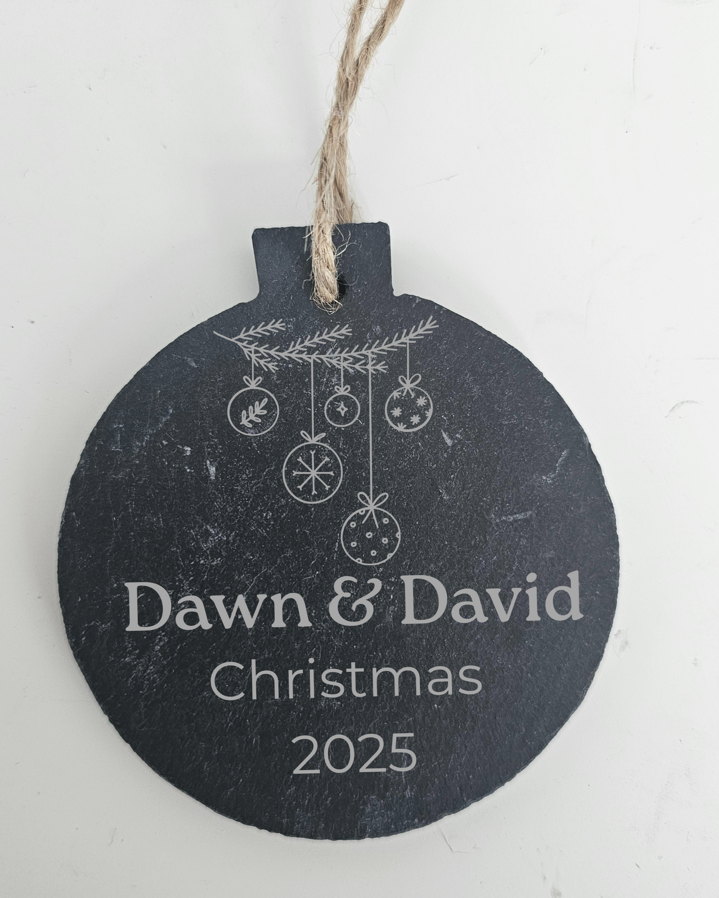 Decorative Christmas ornament with 'Dawn & David Christmas 2025' text on a white background