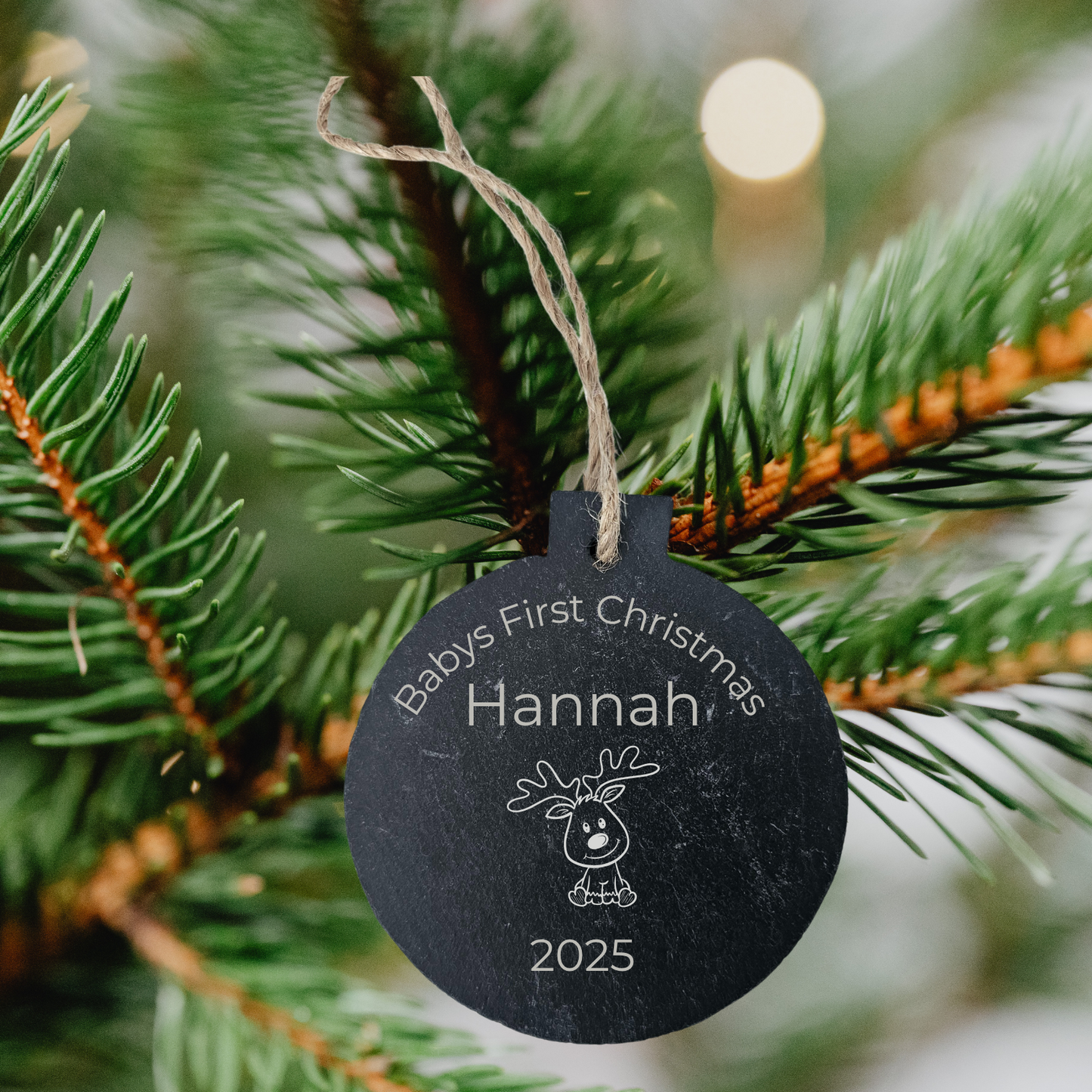 Personalised slate Christmas bauble with 'Happy Christmas Hannah' on a pine branch.