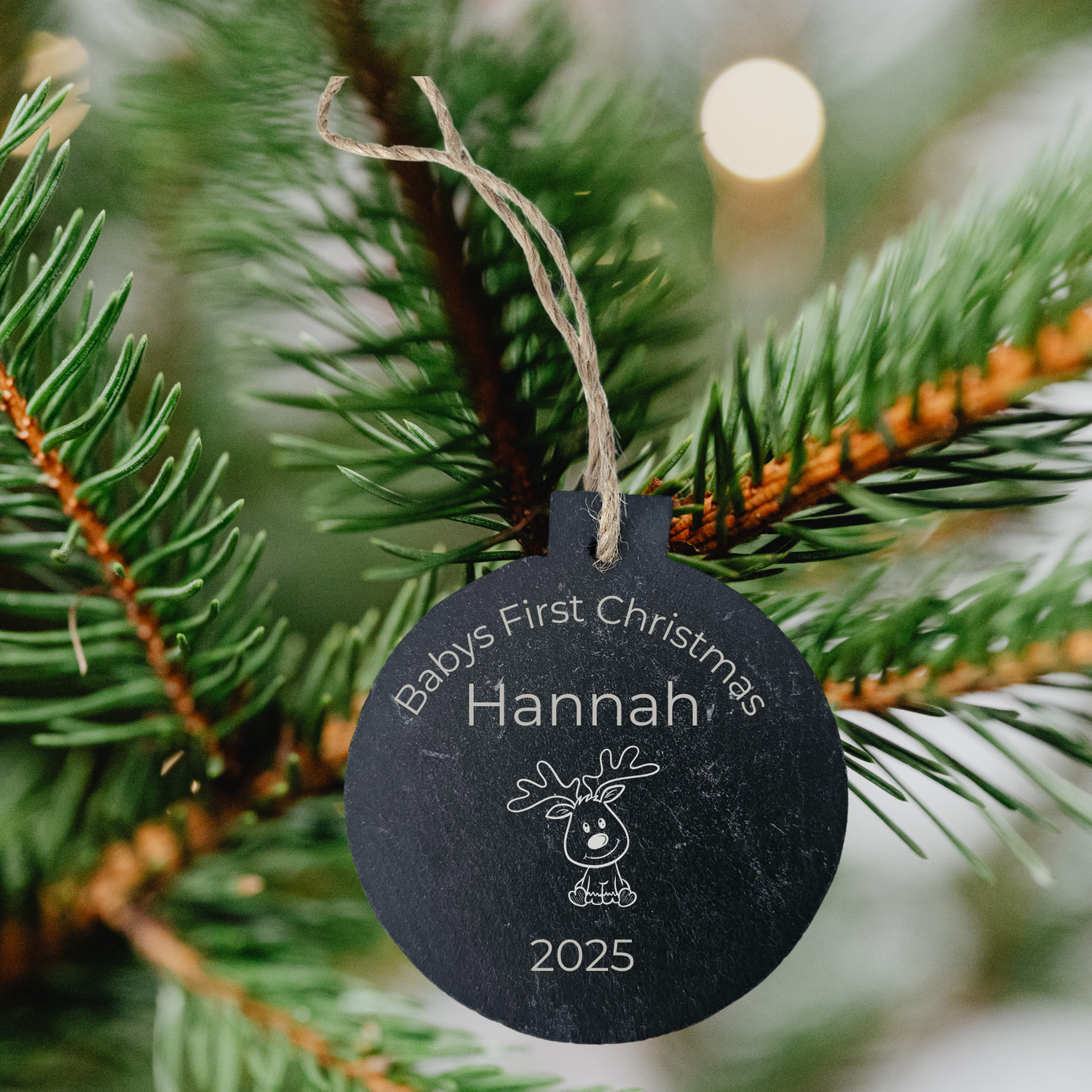 Personalised slate Christmas bauble with 'Happy Christmas Hannah' on a pine branch.