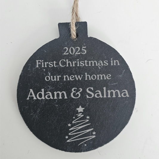 Personalised Round slate bauble with text '2025 First Christmas in our new home Adam & Salma' on a white background