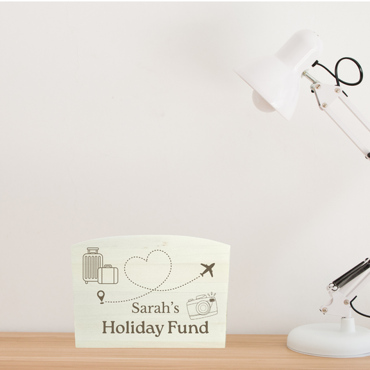Desk with a lamp and a personalised money box  on a white background