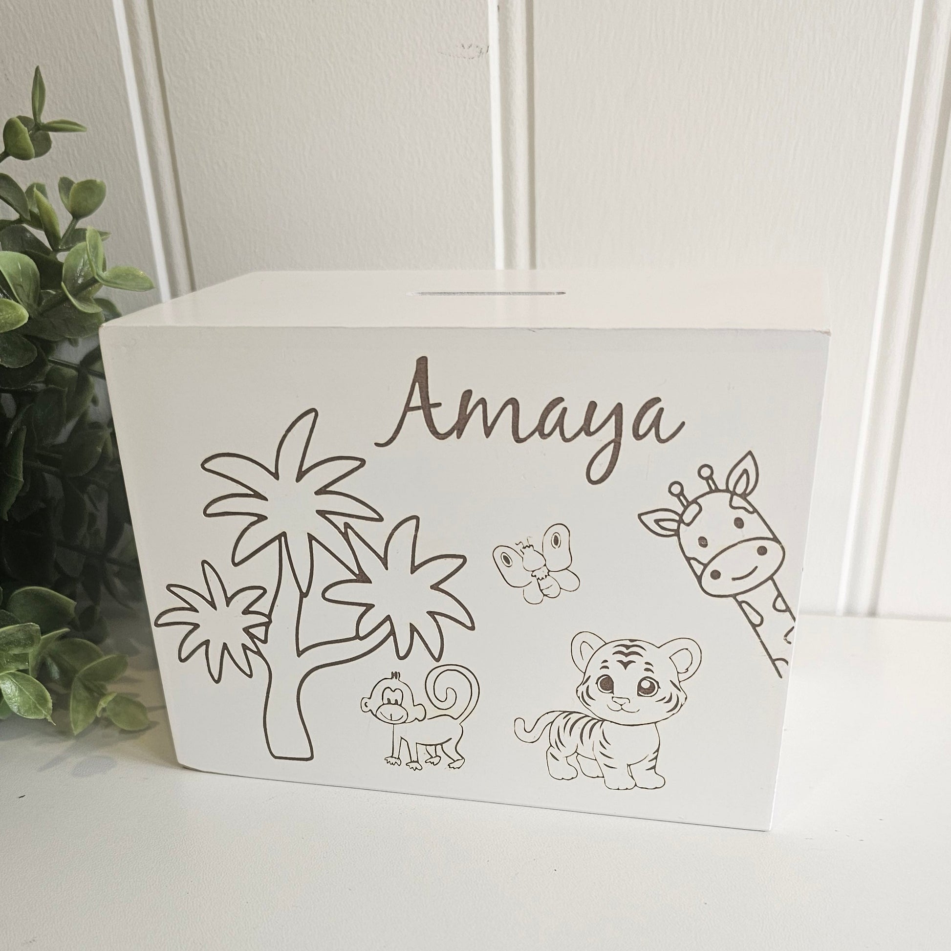 White decorative box with animal illustrations and the name 'Amaya' on a white surface.
