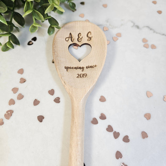wooden spoon with initials and spooning since 2019 engraved in it with a cut out heart in centre