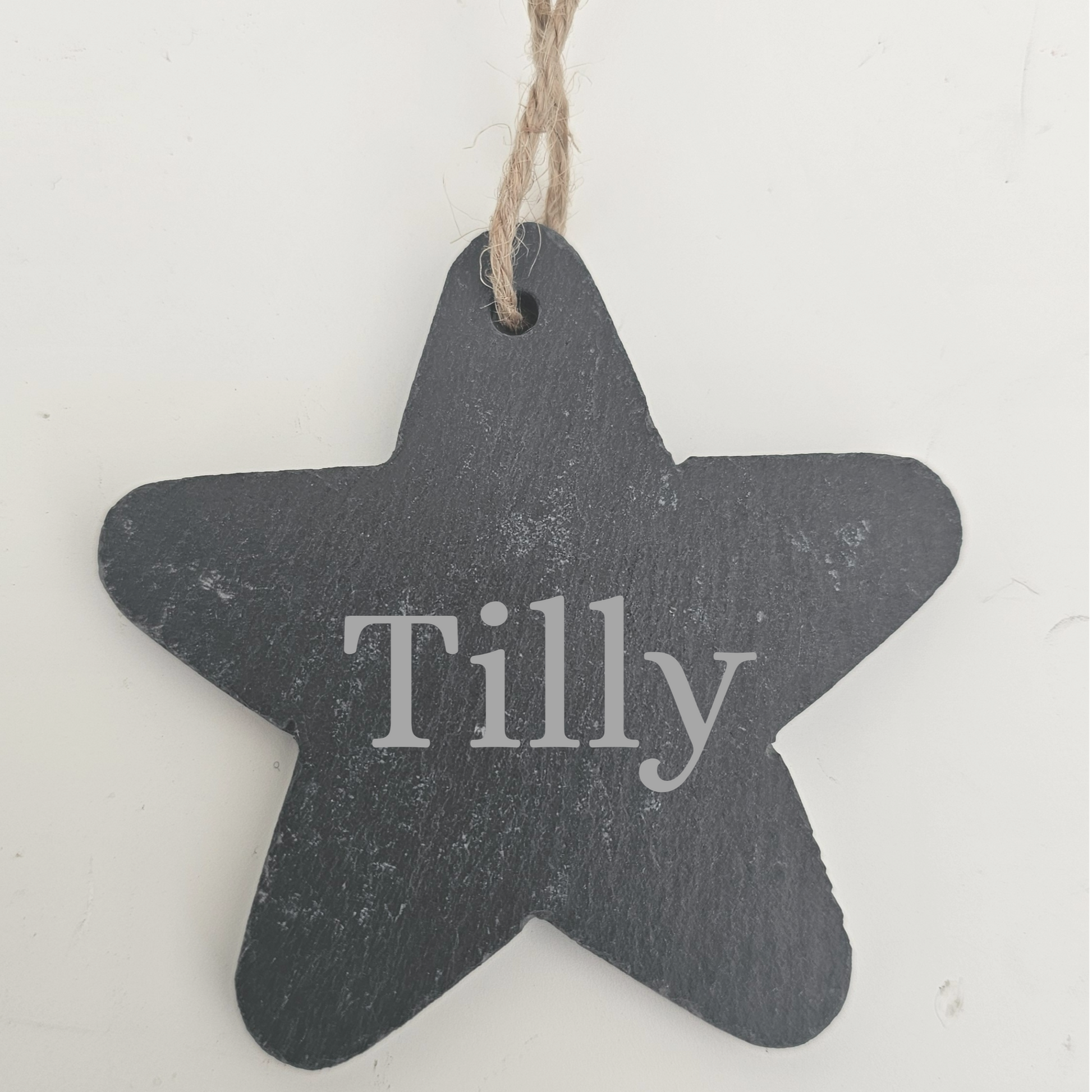 Star-shaped slate tag with 'Tilly' engraved on a white background